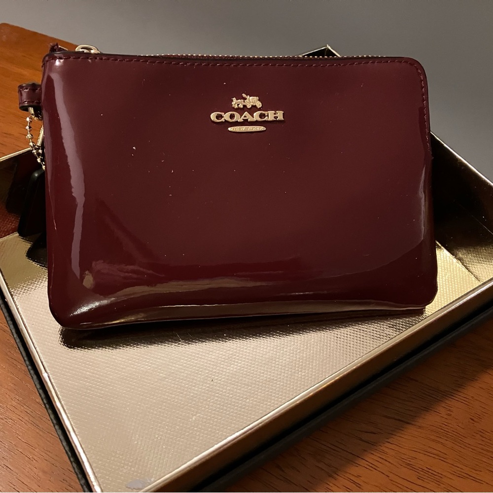 Coach chestnut leather wristlet.